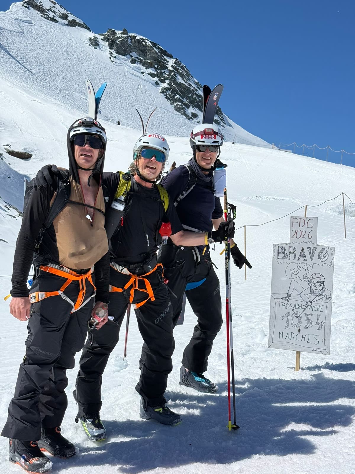 Three of us at the top of the Rosa Blanche bootpack — PDG 2026 BRAVO sign, 1,054 marches